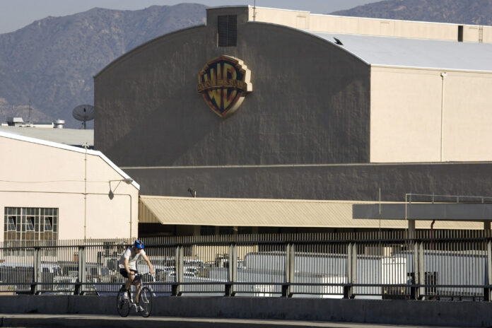 Signage is displayed on the Warner Bros Entertainment Inc. Studios building in Burbank, California, U.S., on Saturday, Dec. 11, 2010. Sales for Hollywood studios in 2010 may fall below 2009's record $10.6 billion, unless films opening between Thanksgiving and New Year's, which is the second most lucrative period after summer with 20 percent of annual sales, draw big audiences. Photographer: Jonathan Alcorn/Bloomberg