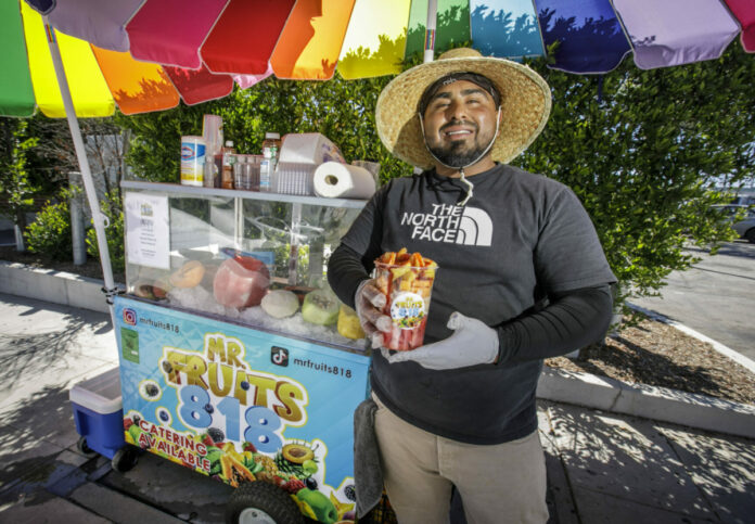 Andrew Gallegos, aka Mr. Fruits818, at his fruit stand outside of a 24 Hour Fitness in Burbank, CA, 2022. Photo by David Sprague