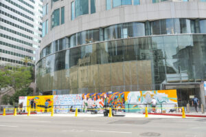 Artists paint construction boards during US Bank Tower renovations.