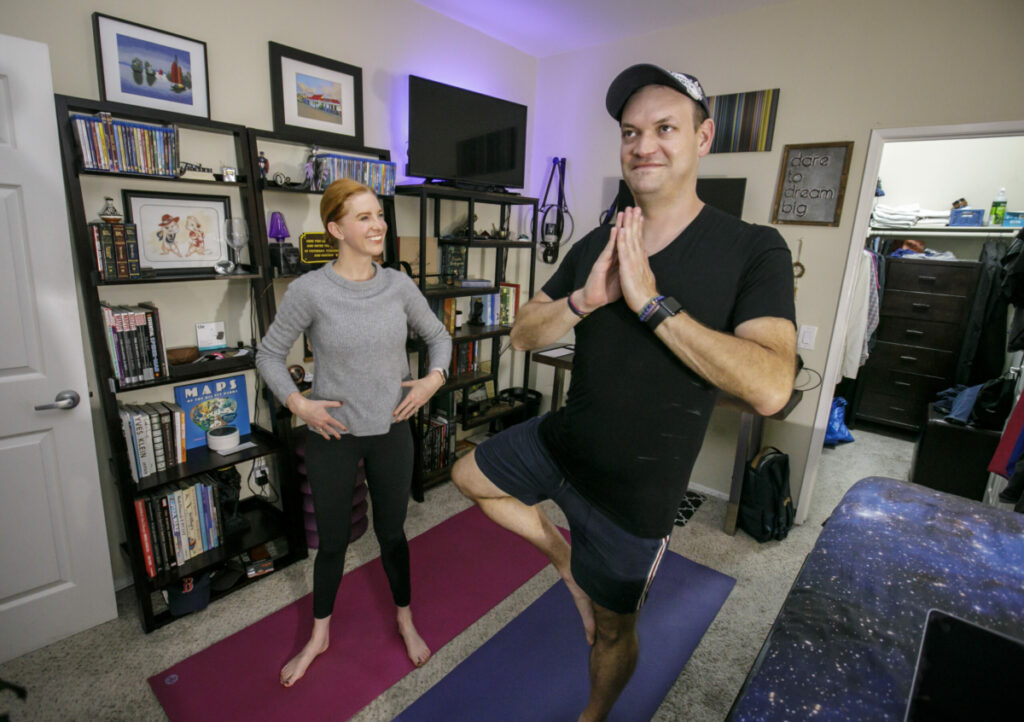 More and more businesses are offering to come to their customer's homes. Here yoga instructor Jessica Bishop works with her client Aaron Hammersly at his home in Burbank, CA recently in October, 2022. Photo by David Sprague
