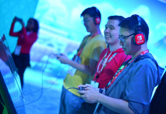 LOS ANGELES, CALIFORNIA - JUNE 11: Convention goers enjoy the exhibits during E3 2019 at the Los Angeles Convention center on June 11, 2019 in Los Angeles, California. (Photo by Charley Gallay/Getty Images for E3/Entertainment Software Association)